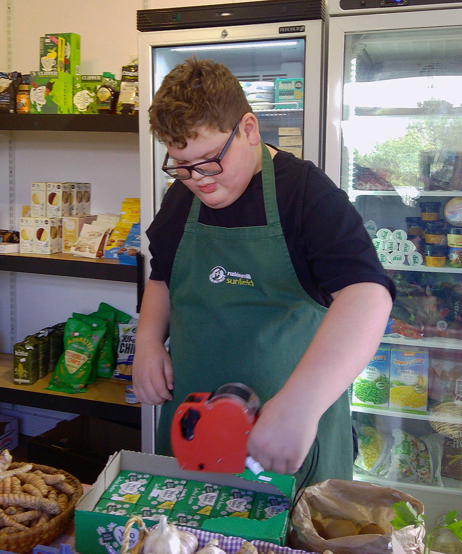 One student is pictured pricing up the butter in the shop, using a pricing gun.